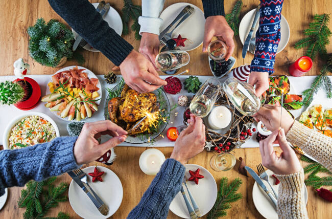 baked-turkey-christmas-dinner-the-christmas-table-is-served-with-turkey-decorated-with-bright-tinsel-and-candles-fried-chicken-table-family-dinner-top-view-hands-in-the-frame